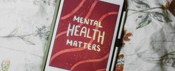 iPad with screensaver saying Mental Health Matters background