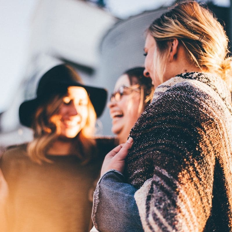 three women friends laughing