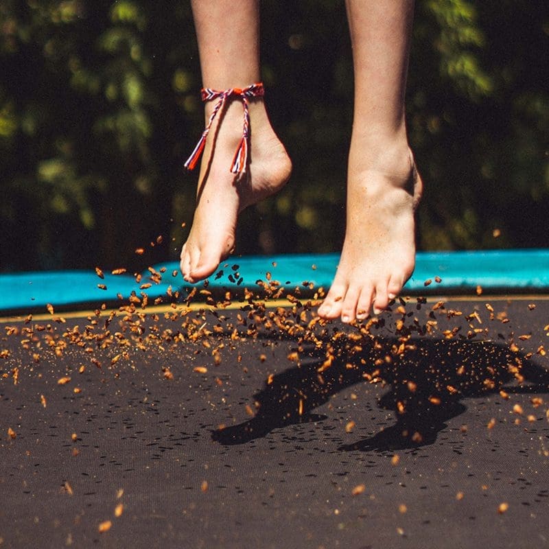 woman jumping on trampoline Woman feet jumping