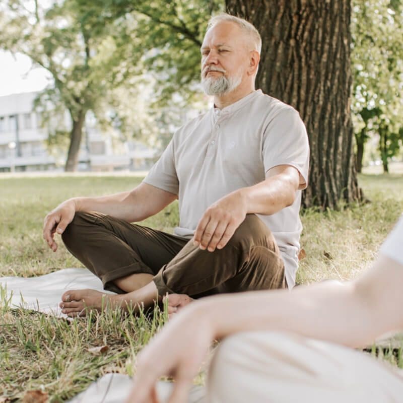 Man doing yoga in park