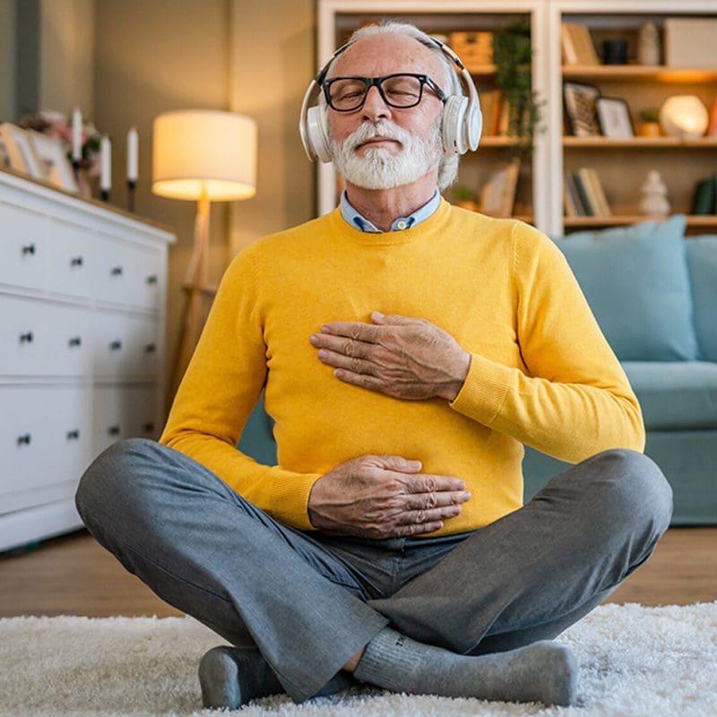 man meditating with headphones