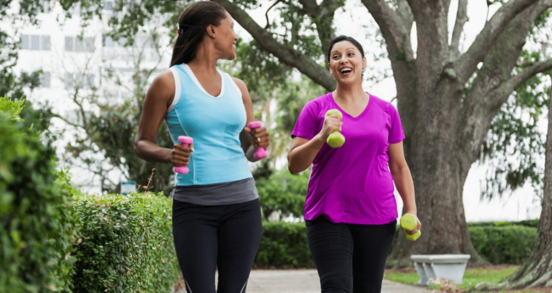 Two woman jogging while holding dumbbells Two woman jogging while holding dumbbells