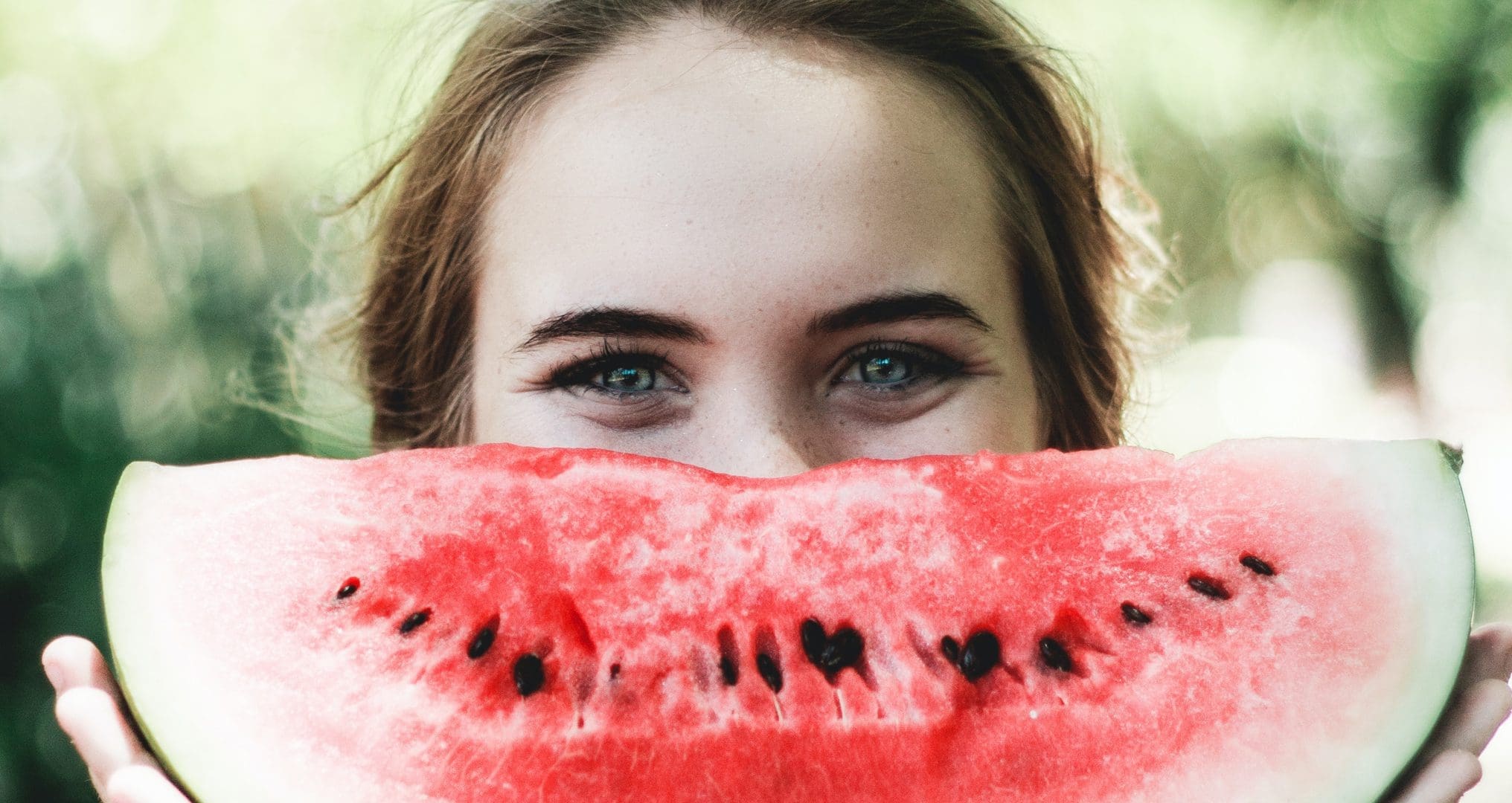 Teenager with a big slice of watermelon