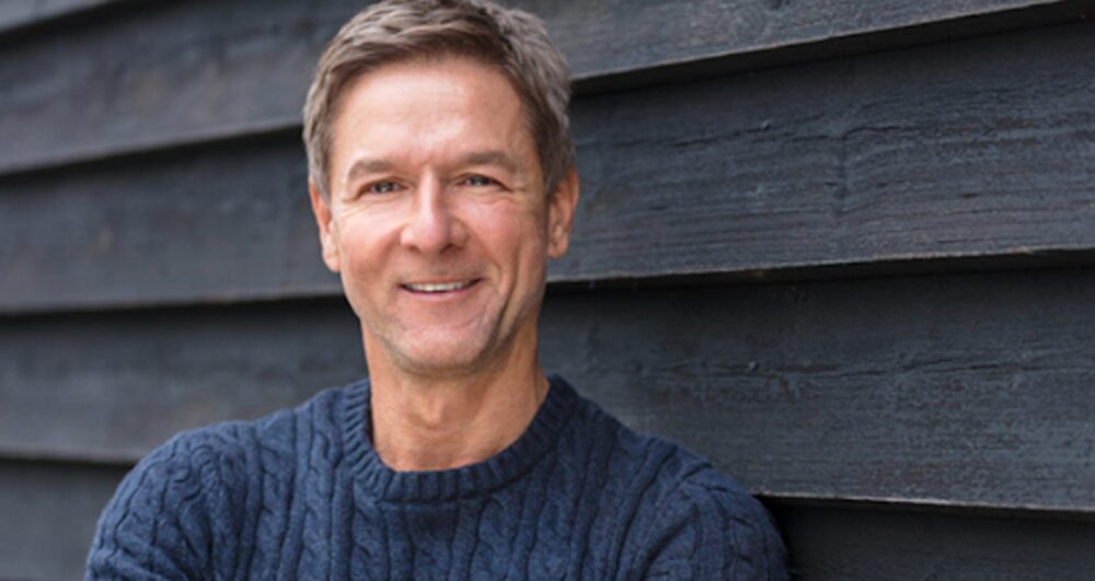 man smiling after finding Grey Matters