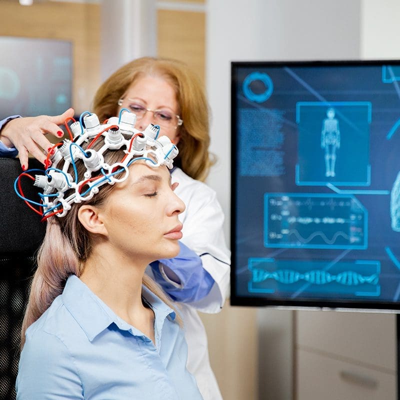 woman getting neurofeedback scan woman getting neurofeedback scan
