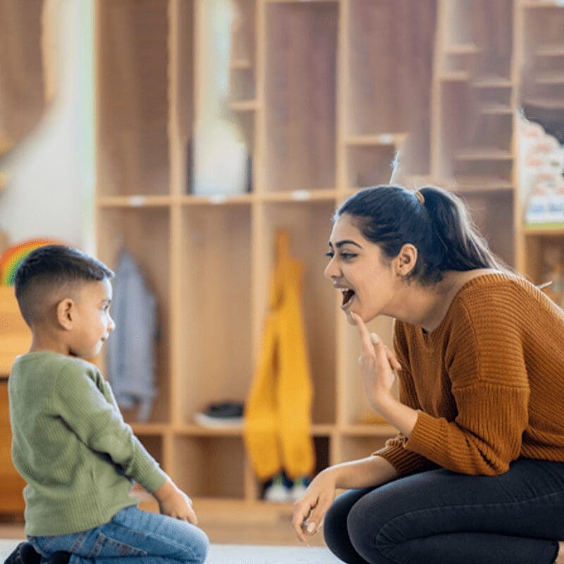 mother teaching her kid to speak