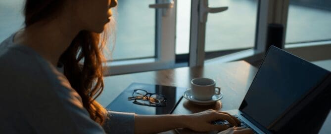 girl sitting at desk working with laptop