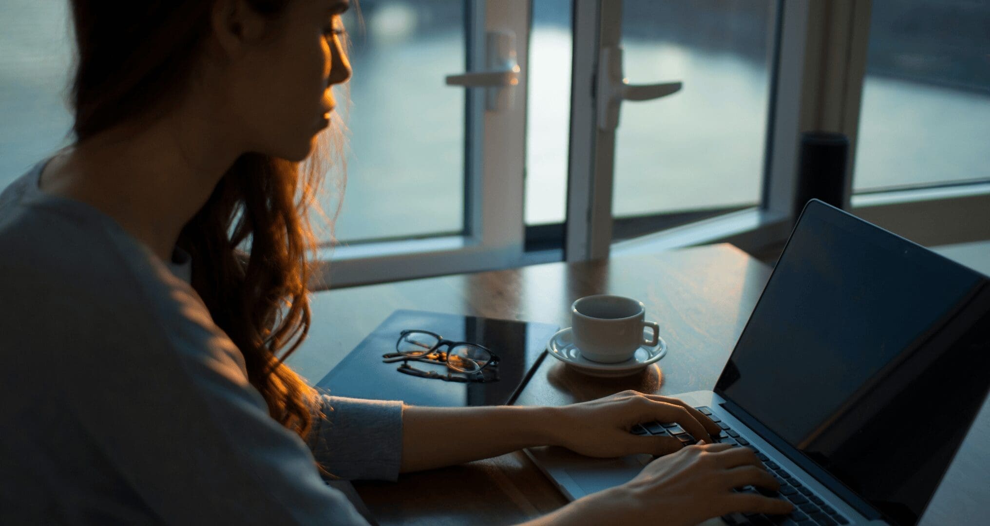 girl sitting at desk working with laptop