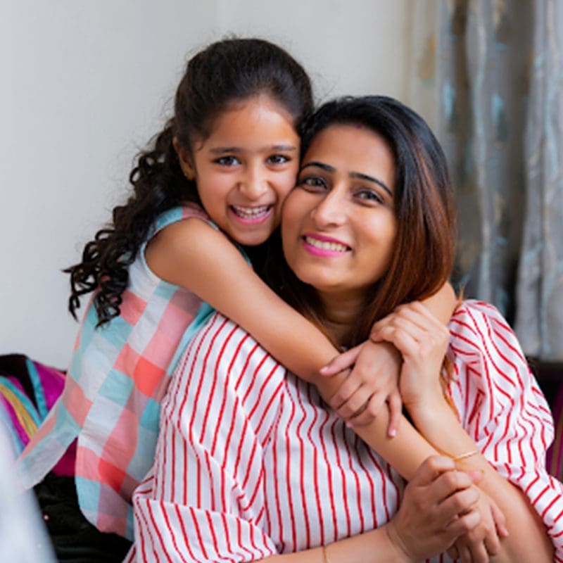 mother and daughter smiling at camera