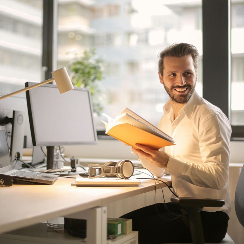 man smiling with book