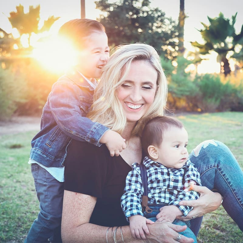 mom smiling with 2 sons