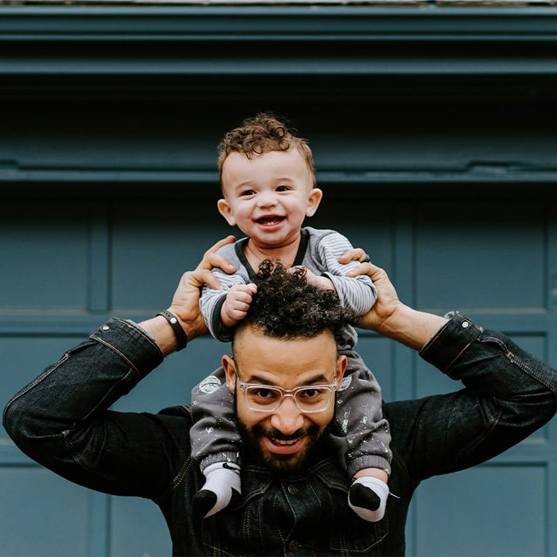 son on dad's shoulders