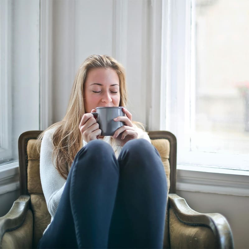 happy woman sitting with coffee