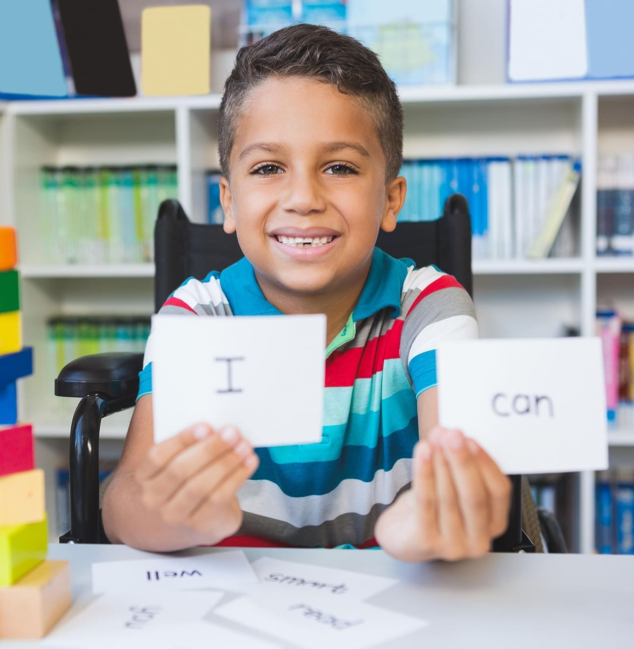 Child holding flash cards to form a sentence