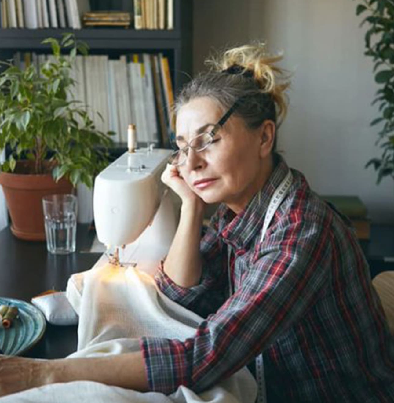 woman falling asleep while sewing