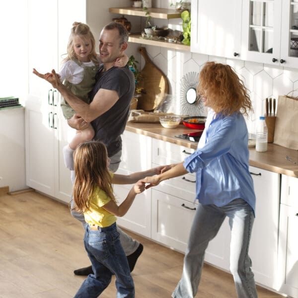 family dancing in the kitchen