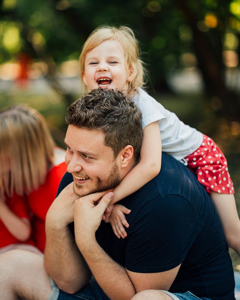 Father and daughter laughing at the park