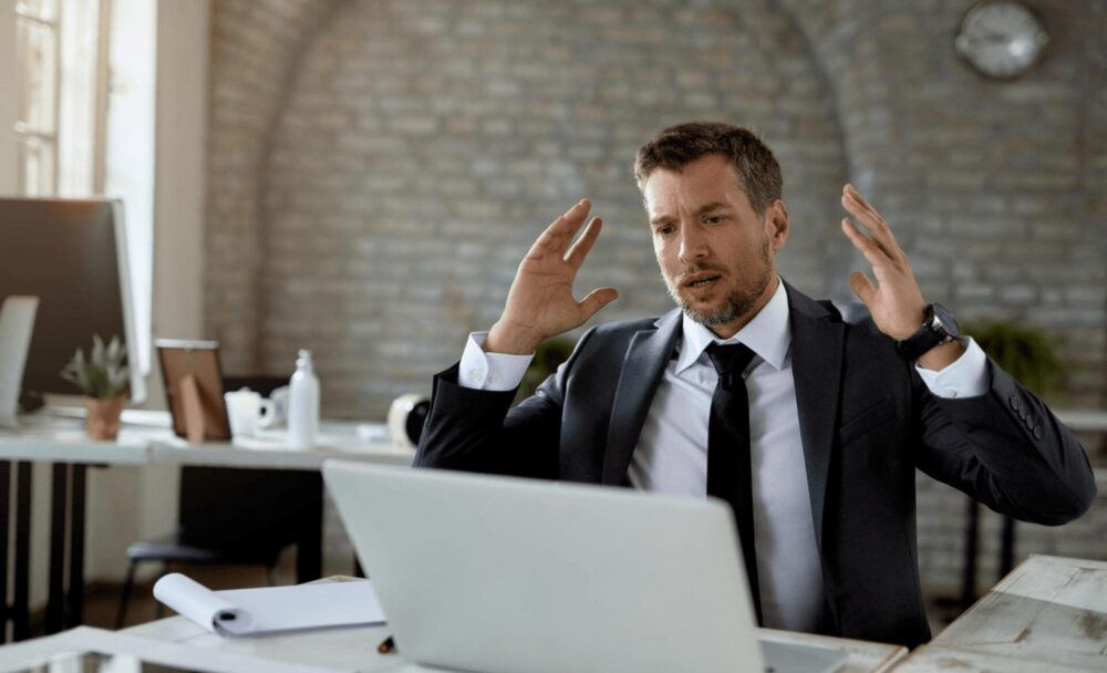 male office worker feeling angry and frustrated