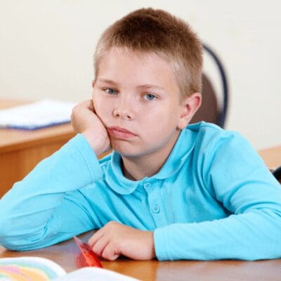 bored-little-boy-his-desk