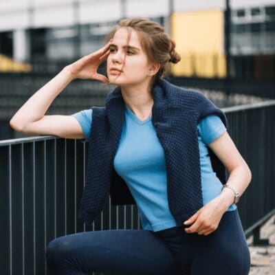 thoughtful-woman rests on handrail stops to think