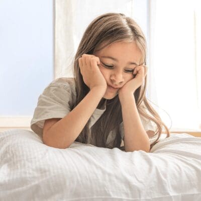 tired girl having trouble falling asleep