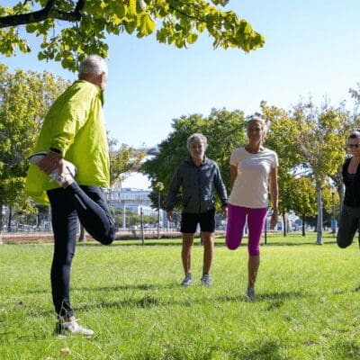 active-mature-people-wearing-sports-clothes-doing-morning-exercise-park