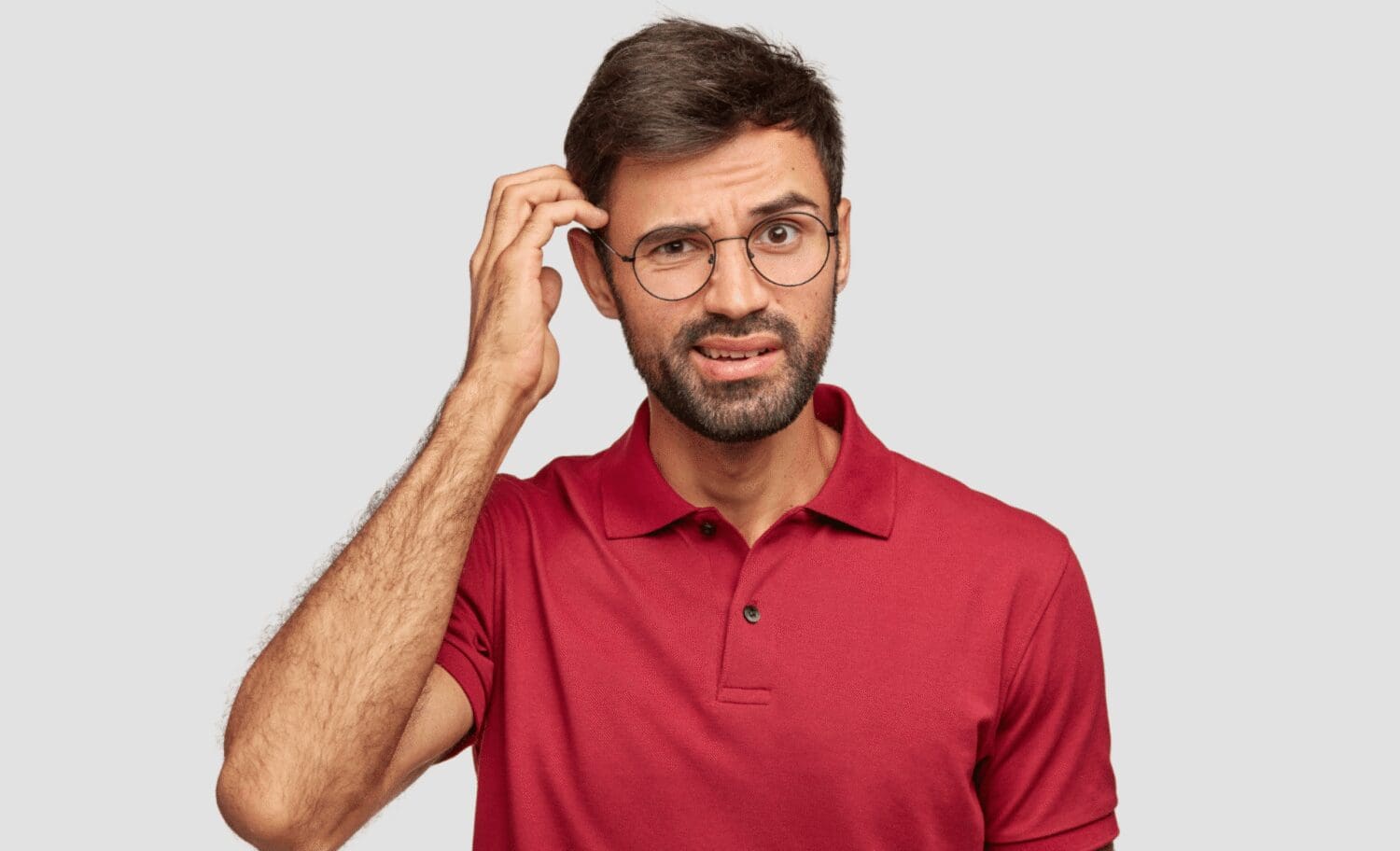 young man holding head, forgetting something, brain fog