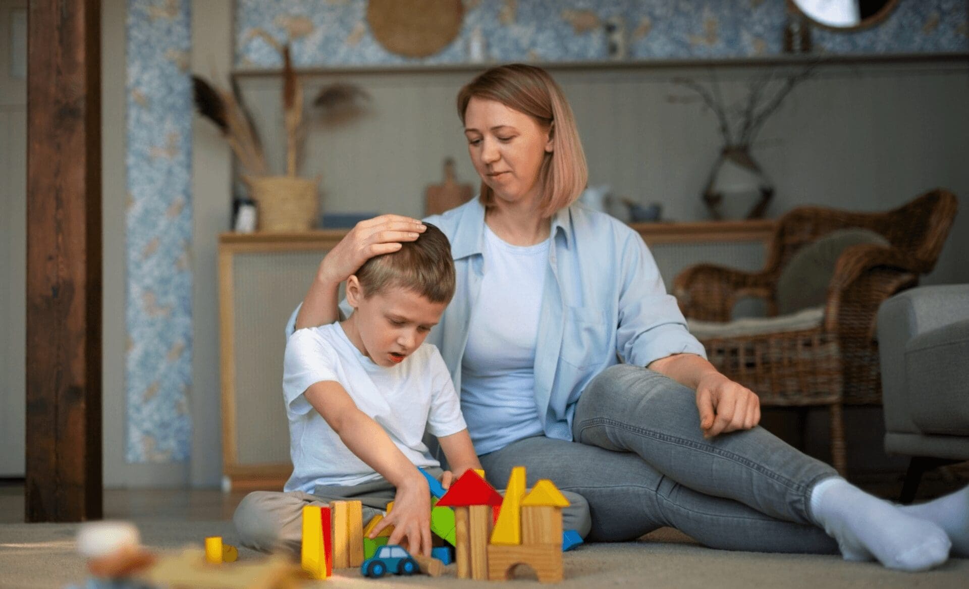 mother playing with level 1 autistic son using toys